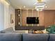 Modern living room boasts stylish decor, wood paneling, sleek entertainment center, and a cozy seating area at 4473 Kaipo Rd, Davenport, FL 33897