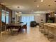 Bright and airy living room featuring modern light fixtures, sleek furniture, and an open floor plan at 4473 Kaipo Rd, Davenport, FL 33897