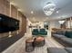 Spacious living room flows into an open kitchen and dining area, all with modern decor and lighting at 4473 Kaipo Rd, Davenport, FL 33897