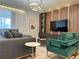 Bright and airy living room with stylish furnishings, wood paneling, and modern lighting features a cozy vibe at 4473 Kaipo Rd, Davenport, FL 33897