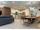 Open concept living and dining area with modern furnishings, light fixtures, and a neutral color palette at 4473 Kaipo Rd, Davenport, FL 33897