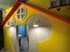 Custom-built playhouse design in a playroom with unique cartoon character murals at 4473 Kaipo Rd, Davenport, FL 33897