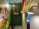 Playroom featuring cartoon character mural and custom-built playhouse design at 4473 Kaipo Rd, Davenport, FL 33897