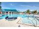 Resort-style pool with lounge chairs and umbrellas offers a relaxing and luxurious environment at 4473 Kaipo Rd, Davenport, FL 33897