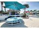 Relaxing lounge area near a pool features a large umbrella and cushioned seating for a resort-style experience at 4473 Kaipo Rd, Davenport, FL 33897