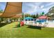 Community splash pad area with colorful water features, lounge chairs and shaded seating at 4473 Kaipo Rd, Davenport, FL 33897