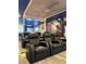 Home theater with comfortable leather recliners and a large Marvel-themed mural at 4473 Kaipo Rd, Davenport, FL 33897
