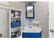 Bathroom with a blue vanity and a white storage shelf at 4722 Kilt Ct # 65, St Cloud, FL 34769