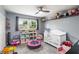 bedroom featuring a ceiling fan, crib, and play area at 4722 Kilt Ct # 65, St Cloud, FL 34769