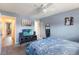 Comfortable bedroom with a ceiling fan and a TV on a media console at 4722 Kilt Ct # 65, St Cloud, FL 34769