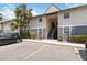 Exterior angle of condo featuring staircase entry and maintained landscaping at 4722 Kilt Ct # 65, St Cloud, FL 34769