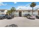 Condo exterior featuring well-maintained landscaping and ample parking at 4722 Kilt Ct # 65, St Cloud, FL 34769