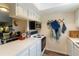Bright kitchen featuring white cabinetry, updated appliances, and wood-look flooring at 4722 Kilt Ct # 65, St Cloud, FL 34769