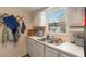 Bright kitchen featuring a stainless steel sink, window, and white cabinetry at 4722 Kilt Ct # 65, St Cloud, FL 34769