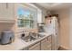 Practical kitchen featuring white cabinets, stainless steel sink, and updated appliances at 4722 Kilt Ct # 65, St Cloud, FL 34769