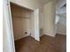 Empty bedroom with light neutral colored walls, electrical panel, tile flooring, and small closet at 4726 Hemingway House St, Kissimmee, FL 34746