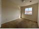 Bright bedroom with a window overlooking a neighborhood home at 4726 Hemingway House St, Kissimmee, FL 34746