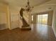 The living room has tile floors, staircase, and a chandelier. It offers ample space for entertaining at 4726 Hemingway House St, Kissimmee, FL 34746