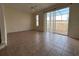 Bright living room featuring tile floors, neutral paint, a ceiling fan, and sliding glass doors at 4726 Hemingway House St, Kissimmee, FL 34746