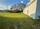 Sprawling backyard features lush grass and mature trees, providing ample space at 505 Peace Way, Poinciana, FL 34759