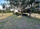 Expansive backyard with mature trees, offering shade and privacy, ideal for outdoor enjoyment at 505 Peace Way, Poinciana, FL 34759