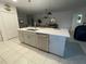 A modern kitchen island featuring stainless steel appliances, gray cabinets, and a double sink, perfect for meal prep at 505 Peace Way, Poinciana, FL 34759