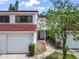 Inviting townhome featuring a two-car garage and a red tile roof, nestled in a charming neighborhood at 5077 Ernst Ct # 3, Orlando, FL 32819