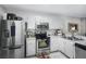 Well-lit kitchen with stainless steel appliances, white cabinets, and stylish backsplash at 5077 Ernst Ct # 3, Orlando, FL 32819