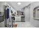 Bright kitchen showcasing stainless appliances, white cabinets and a view of the dining area at 5077 Ernst Ct # 3, Orlando, FL 32819