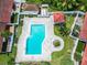Aerial view of community pool, showcasing the large pool deck and surrounding landscaping within the fenced area at 5077 Ernst Ct # 3, Orlando, FL 32819