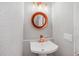 Stylish powder room featuring modern fixtures, decorative mirror, and a clean, minimalist design at 5077 Ernst Ct # 3, Orlando, FL 32819