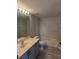 Bathroom features a vanity with cabinet, shower-tub combo with tile surround, and gray walls at 511 Elbridge Pl, Kissimmee, FL 34758