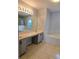 Bathroom featuring dual sinks, large mirrors, tile floors and a soaking tub at 511 Elbridge Pl, Kissimmee, FL 34758