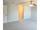 Bedroom with carpet floors featuring a ceiling fan, a white door and a closet at 511 Elbridge Pl, Kissimmee, FL 34758