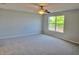 Bedroom with carpet floors, large window, and a ceiling fan at 511 Elbridge Pl, Kissimmee, FL 34758