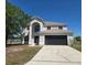 Charming two-story home with a two car garage and a well-manicured lawn at 511 Elbridge Pl, Kissimmee, FL 34758