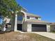 Two-story home featuring a two car garage, arched entryway, and lovely curb appeal at 511 Elbridge Pl, Kissimmee, FL 34758