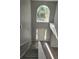 Bright foyer featuring a large window, hardwood floors, and a staircase with carpeted steps at 511 Elbridge Pl, Kissimmee, FL 34758