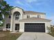 Two-story home featuring an attached two car garage, and large archway above the front door at 511 Elbridge Pl, Kissimmee, FL 34758