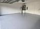 Spacious garage with gray epoxy flooring at 511 Elbridge Pl, Kissimmee, FL 34758