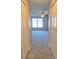 Hallway with carpet floors between two closets leading to a bedroom with a ceiling fan at 511 Elbridge Pl, Kissimmee, FL 34758