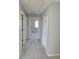 Carpeted hallway features neutral walls, with storage, and a view of an adjacent room at 511 Elbridge Pl, Kissimmee, FL 34758