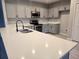 Bright kitchen features stainless steel appliances, a double sink, and gray cabinets at 511 Elbridge Pl, Kissimmee, FL 34758