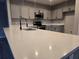 Bright kitchen features stainless steel appliances, a double sink, and gray cabinets at 511 Elbridge Pl, Kissimmee, FL 34758