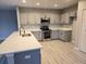 Bright kitchen features stainless steel appliances, a double sink, and gray cabinets at 511 Elbridge Pl, Kissimmee, FL 34758