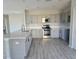 Bright kitchen features stainless steel appliances and gray cabinets at 511 Elbridge Pl, Kissimmee, FL 34758