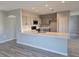 Well-lit kitchen boasting quartz counters, stainless appliances, and plentiful storage space at 511 Elbridge Pl, Kissimmee, FL 34758