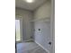 Laundry room featuring gray walls, a utility sink, and a door to the outside at 511 Elbridge Pl, Kissimmee, FL 34758