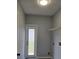 Laundry room featuring gray walls, a utility sink, and a door to the outside at 511 Elbridge Pl, Kissimmee, FL 34758