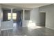 Bright living room featuring stylish gray walls, wood-look flooring, and decorative columns at 511 Elbridge Pl, Kissimmee, FL 34758